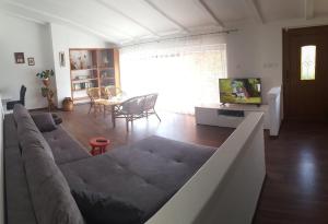 a living room with a couch and a tv at Apartments with a parking space Liznjan, Medulin - 13164 in Ližnjan