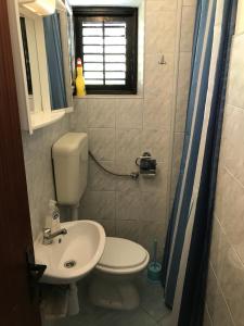 a small bathroom with a toilet and a sink at Double Room Gradac 13179a in Gradac