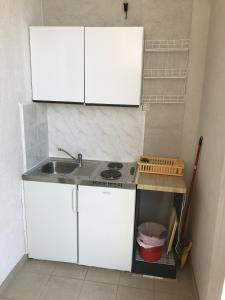 a small kitchen with white cabinets and a sink at Double Room Gradac 13179a in Gradac
