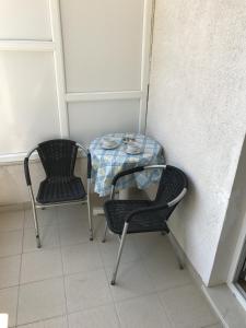 uma mesa e duas cadeiras sentadas ao lado de uma parede em Double Room Gradac 13179a em Gradac