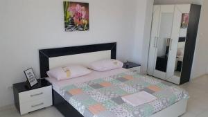 a bedroom with a large bed and a mirror at Apartments by the sea Gradac, Makarska - 13181 in Gradac