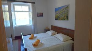 a bedroom with a bed with two towels on it at Apartments by the sea Broce, Peljesac - 13182 in Ston