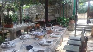 a table set up for a meal in a garden at Rooms with a parking space Bratulici, Marcana - 13188 in Hreljići