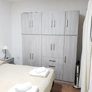 サルタにあるDUO HOMEの白いタオルが敷かれたベッドのある寝室