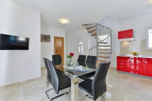 a dining room with a table and chairs and a staircase at Apartment Nin 13172c in Nin