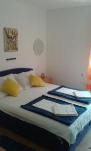 a bedroom with a bed with towels on it at Apartments with a parking space Gradac, Makarska - 13196 in Gradac