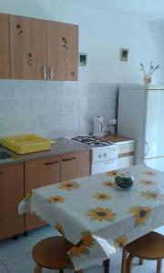 a kitchen with a table with a flower table cloth on it at Apartments with a parking space Gradac, Makarska - 13196 in Gradac