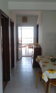a kitchen with a table and a view of a room at Apartments with a parking space Gradac, Makarska - 13196 in Gradac
