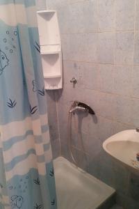 a bathroom with a shower curtain and a sink at Apartments with parking space Novalja, Pag - 13200 in Novalja
