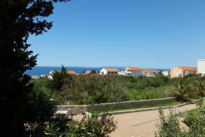 a view of a park with houses and the ocean at Apartments with parking space Novalja, Pag - 13200 in Novalja