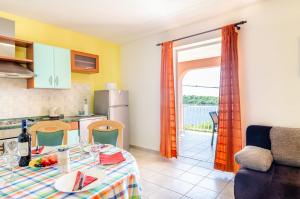 a kitchen and a dining room with a table and a kitchen at Apartments by the sea Karbuni, Korcula - 13217 in Prizba
