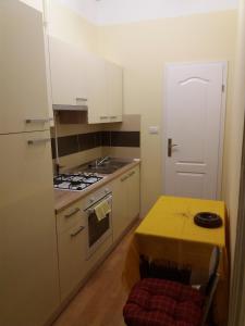 a small kitchen with a table and a stove at Apartments by the sea Rijeka - 13293 in Rijeka