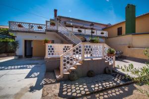 a house with a staircase in front of it at Apartments with a parking space Malinska (Krk) - 13219 in Malinska