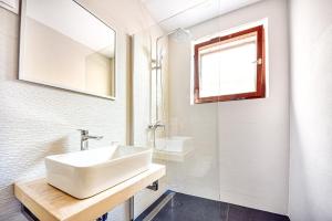 a white bathroom with a sink and a mirror at Apartments and rooms by the sea Puntinak, Brac - 12255 in Selca