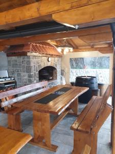 a large wooden table in a kitchen with a stone oven at Apartments with a parking space Kastav, Opatija - 13457 in Kastav