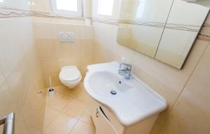 a white bathroom with a sink and a toilet at Apartments with a parking space Kastav, Opatija - 13457 in Kastav