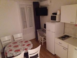 a kitchen with a table and a small kitchen with a table and chairs at Apartments with WiFi Vis - 13442 in Vis