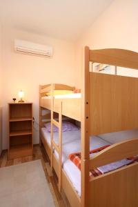 a bedroom with two bunk beds in a room at Apartments with a parking space Orebic, Peljesac - 10097 in Orebić