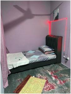 a bedroom with a bed with a shadow on the wall at Cheerfull3 bedroom townhouse Terrace in Kampung Dengkil