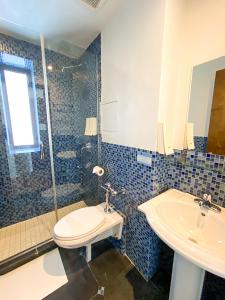 a bathroom with a toilet and a sink and a shower at JG Sohotel in New York