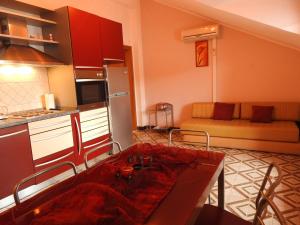 a kitchen and a living room with a table and a couch at Apartments by the sea Brna, Korcula - 13492 in Smokvica +31 photos
