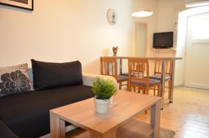 a living room with a couch and a table at Apartments by the sea Cres - 13510 in Cres