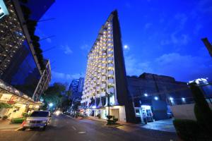 a tall building on a city street at night at Hotel Century Reforma in Mexico City +37 photos
