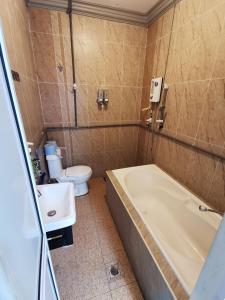 a bathroom with a tub and a toilet and a sink at Ourstay Nadi Kota in Bandar  Pusat Jengka