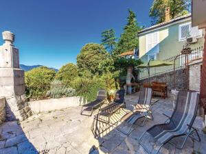 a patio with chairs and a table and a building at Apartments with a parking space Kastav, Opatija - 13568 in Kastav