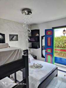 a bedroom with a bed and a colorful door at CASABOUTIQUE HOTEL in Salento