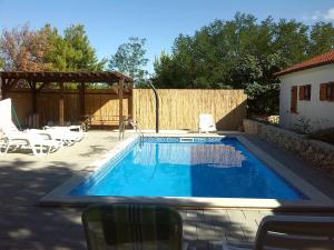 a swimming pool in the backyard of a house at Family friendly apartments with a swimming pool Vir - Lozice, Vir - 13569 in Vir