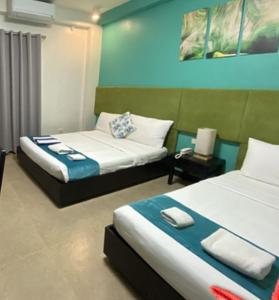 a room with two beds at Residencia Boracay in Boracay