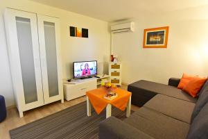 a living room with a couch and a television at Apartments with parking space Savudrija, Umag - 13589 in Savudrija