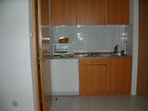a small kitchen with a microwave and a sink at Apartments and rooms by the sea Lumbarda, Korcula - 13626 in Lumbarda +22 photos