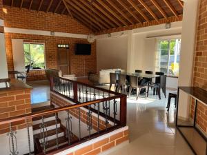 a dining room and living room with a table and chairs at Casa Campestre Veracruz in Pereira