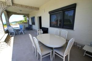 a white table and chairs on a patio at Apartments and rooms by the sea Pirovac, Sibenik - 13654 in Pirovac