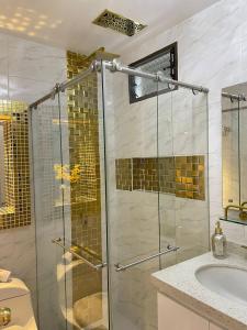 a bathroom with a glass shower and a sink at CASABOUTIQUE HOTEL in Salento