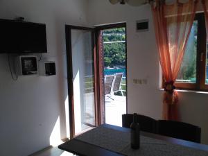 a room with a sliding glass door leading to a patio at Apartments by the sea Prapratno (Peljesac) - 13500 in Ston