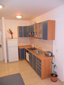 a small kitchen with a sink and a stove at Apartments with a parking space Rogoznica - 13684 in Rogoznica