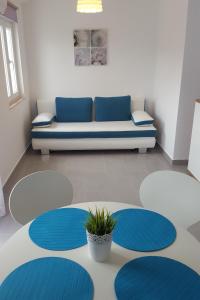 ein Wohnzimmer mit einem Sofa und einer Topfpflanze in der Unterkunft Apartments by the sea Stomorska, Solta - 13695 in Stomorska