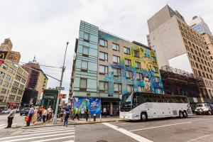 a bus is stopped at an intersection in a city at JG Sohotel in New York