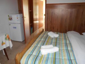 a bedroom with a bed with towels on it at Quadruple Room Rovinj 13591i in Rovinj