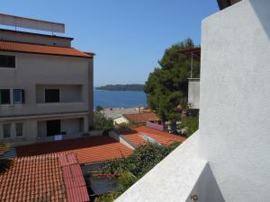 a view of a building with a view of the water at Quadruple Room Rovinj 13591i in Rovinj