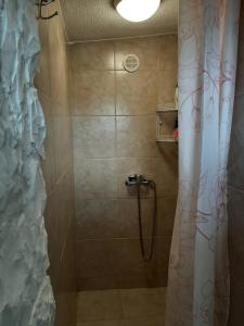 a bathroom with a shower with a shower curtain at Secluded fisherman's cottage Cove Prnjica, Pag - 12620 in Kolan