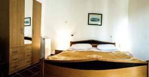 a bedroom with a bed with two pillows on it at Double Room Zambratija 11875a in Zambratija