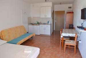 a kitchen with a couch and a table in a room at Studio Gradac 13681a in Gradac