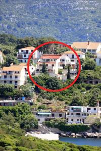 une maison dans une ville avec un cercle rouge dans l'établissement Apartments with a parking space Zavalatica, Korcula - 9690, à Zavalatica