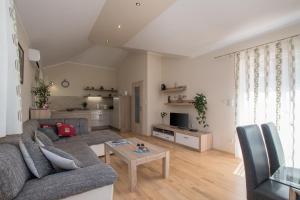 a living room with a couch and a table at Holiday house with a parking space Kastel, Central Istria - Sredisnja Istra - 14572 in Buje