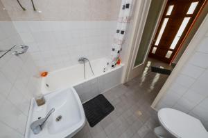 a bathroom with a sink and a tub and a toilet at Apartments by the sea Kastel Stari, Kastela - 14577 in Kaštela