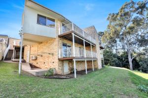 a brick house with a staircase on the side of it at LAKESIDE2 in Merimbula